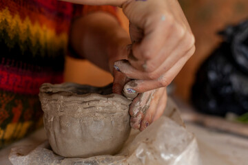 close up of hands of a potter