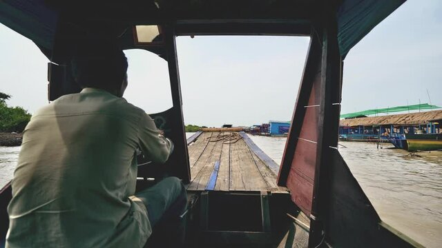 Local Helmsman Steers on a Muddy River 