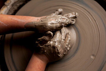 hands of child potter