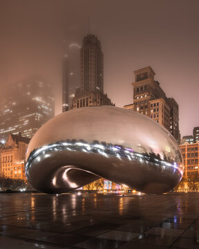 CHICAGO, ILLINOIS: The Cloud Gate sculpture, known as The Bean, in Millennium Park at night during a foggy evening.