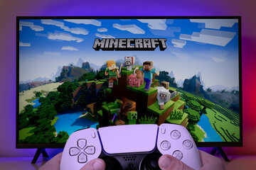 Naklejka premium Kid playing Minecraft with Playstation 5 controller. 24 Jun, 2021, Sao Paulo, Brazil