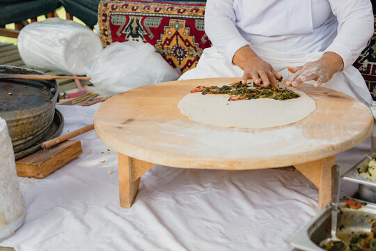 A woman prepares Turkish g&ouml;zleme cakes in a hotel restaurant in Turkey