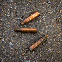 Three old brown bullet casings close up