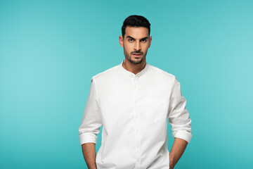 Aggressive arabian man looking at camera isolated on blue