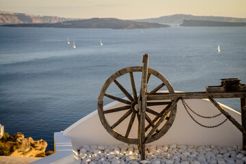 Old wooden wheel on the balcony over the sea