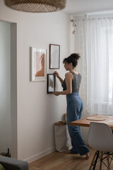 Modern female hanging wall pictures photos in wooden frame decorated scandi minimalistic style room