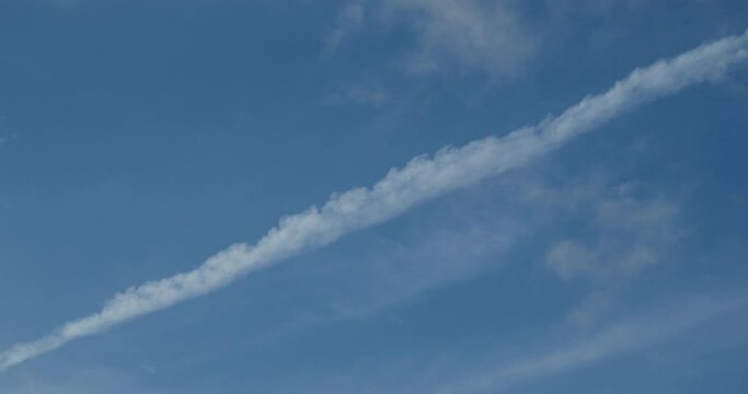 The white trace after plane in the sky.