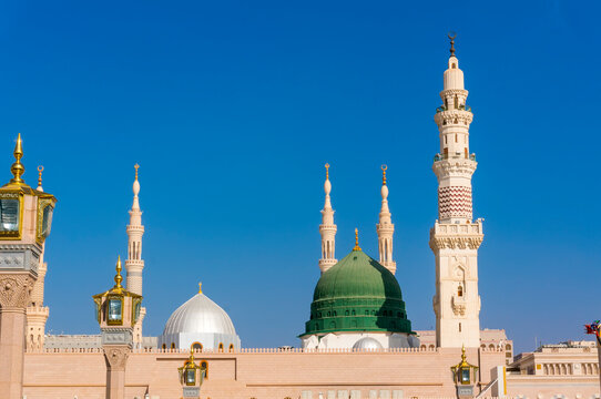 Exterior view of minarets and green dome of a mosque taken off the compound.