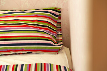 Close up of strips pattern pillow and bed