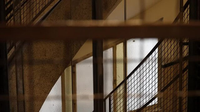 Watching through the steel metal grid of an empty ancient elevator - POV close up