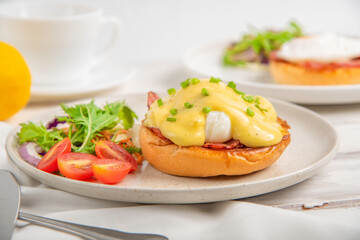 Eggs Benedict on toasted muffins with bacon. hollandaise sauce.breakfast food.