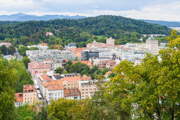 Obraz premium A partial panoramic view under a cloudy sky of central Ljubljana, Slovenia's capital, looking to the Tivoli City Park