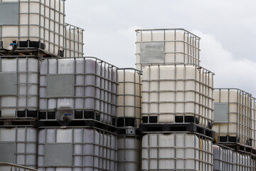 discharge of plastic barrels in warehouse yard.  IBC container in outdoor stock yard of factory.