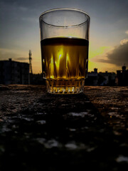 glass of whisky at sunrise morning time