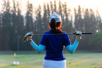 Women golfer Using golf clubs To help twist To warm up body before the play game, with blurred soft nature background,Lifestyle Concept. Sport Concept