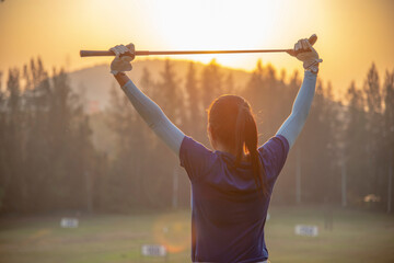 Fototapeta na wymiar Women golfer Using golf clubs To help twist To warm up body before the play game. Sport Concept