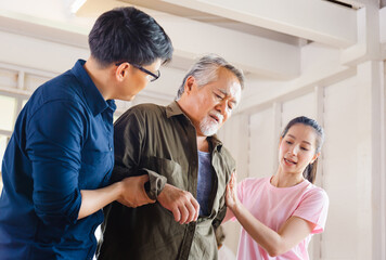 Son and daughter help support a senior father have a backache, Back pain in elderly adults, Asian family concepts