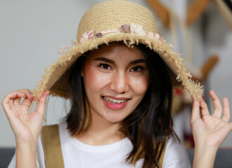closeup face. Beautiful asian woman smiling wearing a hat in order to do online sales. Concept onling shopping live in boardcast.