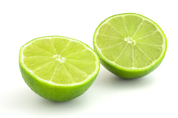 Lime in section isolated on white background. Ripe green citrus for cocktails and alcoholic beverages.