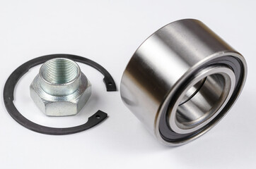Set of auto parts on white background. New Retaining ring, special nut and hub bearing.  Spare...