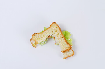 Uneaten Tuna Sandwich on a white background. Half-eaten sandwich