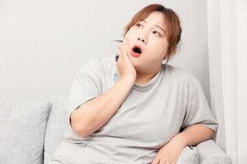 Asian fat girl sitting on the sofa