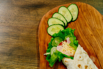 pita with vegetables and chopped cucumbers. vegetarian roll.
