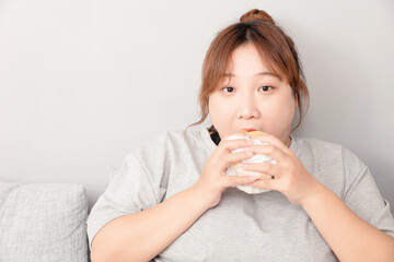 Asian fat girl sitting on the sofa