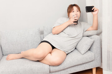 Asian fat girl sitting on the sofa