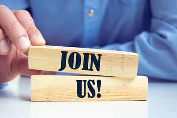 Join us concept on wooden cubes against blue background. Business job vacancy or community...