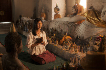 a woman praying  in an ancient thailand temple , at " Wat Samret" Koh samui ,Suratthani