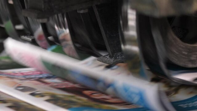 Close up slow motion paper laying machine at printworks