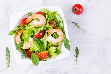 Delicious and healthy shrimp salad with herbs and tomatoes. Dietary nutrition for weight loss. Recipe for cooking fresh seafood. Mediterranean cuisine.
