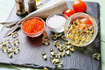 Set of healthy products with fish oil pills on table