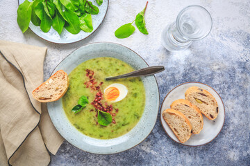Creamy sorrel soup with egg and bacon bits