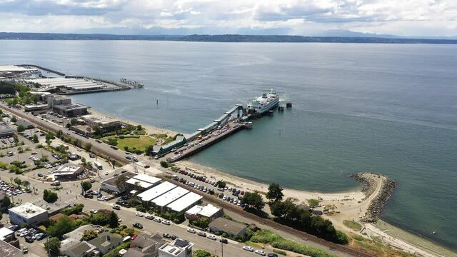 Cinematic 4K drone trucking shot of the Port of Edmonds,  downtown Edmonds commercial area, Kingston ferry terminal waterfront marina, near Seattle, Washington, Pacific Northwest, in Snohomish County