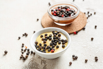 Different sauces with peppercorns on light background