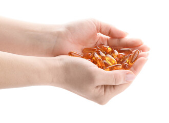 Fototapeta premium Female hands with fish oil capsules on white background