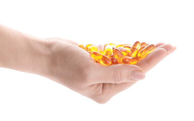Female hand with fish oil capsules on white background