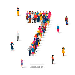 A large group of people is standing in colored clothes in the shape of the number 7. The concept of human numbers.