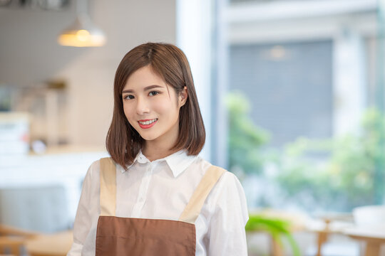 young asian shopkeeper smile