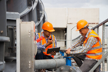 Asian engineer refrigeration plant  factory. male mechanic wearing helmet and Reflective Safety...
