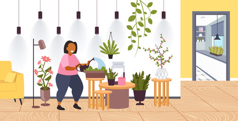 woman with watering can taking care of houseplants girl caring for indoor plants stay home lifestyle