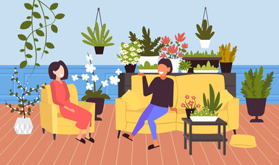girls discussing during meeting women relaxing in modern living room with house plants green indoor