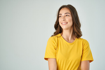 Obraz premium cheerful brunette in a yellow t-shirt posing fashionable hairstyle smile model