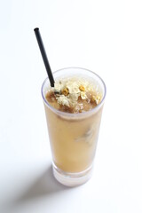 homemade cook ice cold chilled yellow Chrysanthemum flower tea in tall glass white background beverage menu