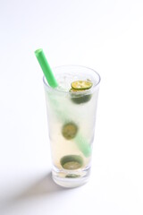 ice cold chilled fresh sour lime fruit honey drink in glass and green straw beverage menu in white background