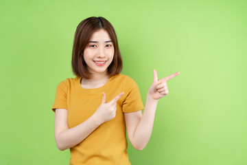 Young asian girl  posing on green background