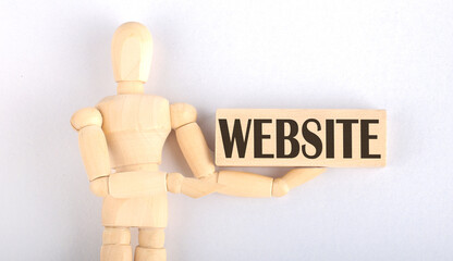 Wooden man shows with a hand to block with text WEBSITE