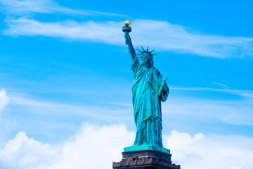 Fototapeta premium Statue of Liberty on the background with clouds and sky, Freedom concept,